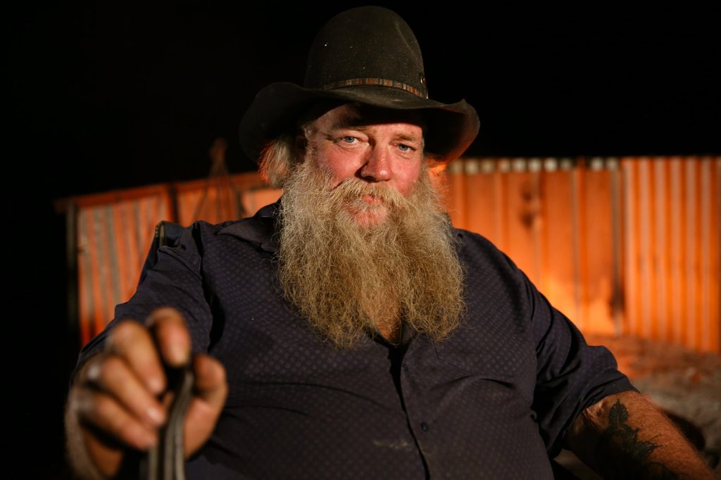 Portrait of a bearded man wearing a black hat