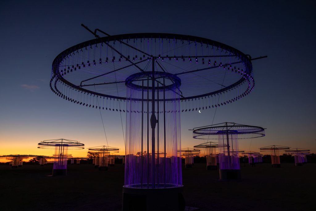 Circular light installation against the evening sky